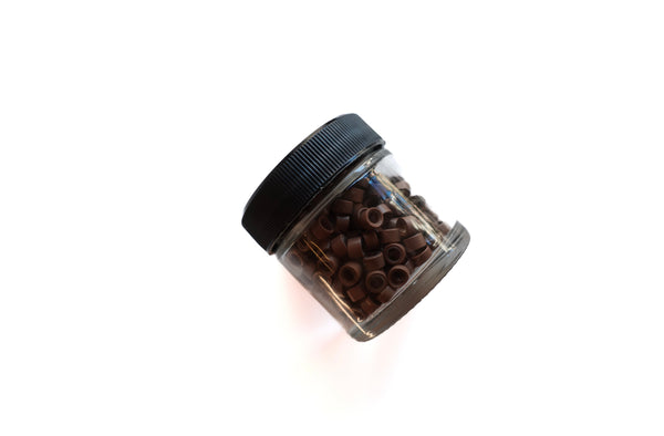 small glass jar of 300 light brown beads