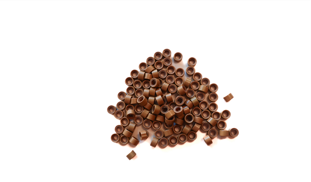 Blonde beads scattered on white background to show true color of the beads