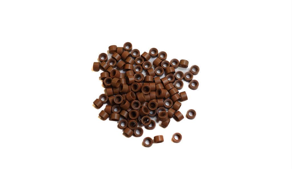 light brown beads scattered on white background to show true color of the beads